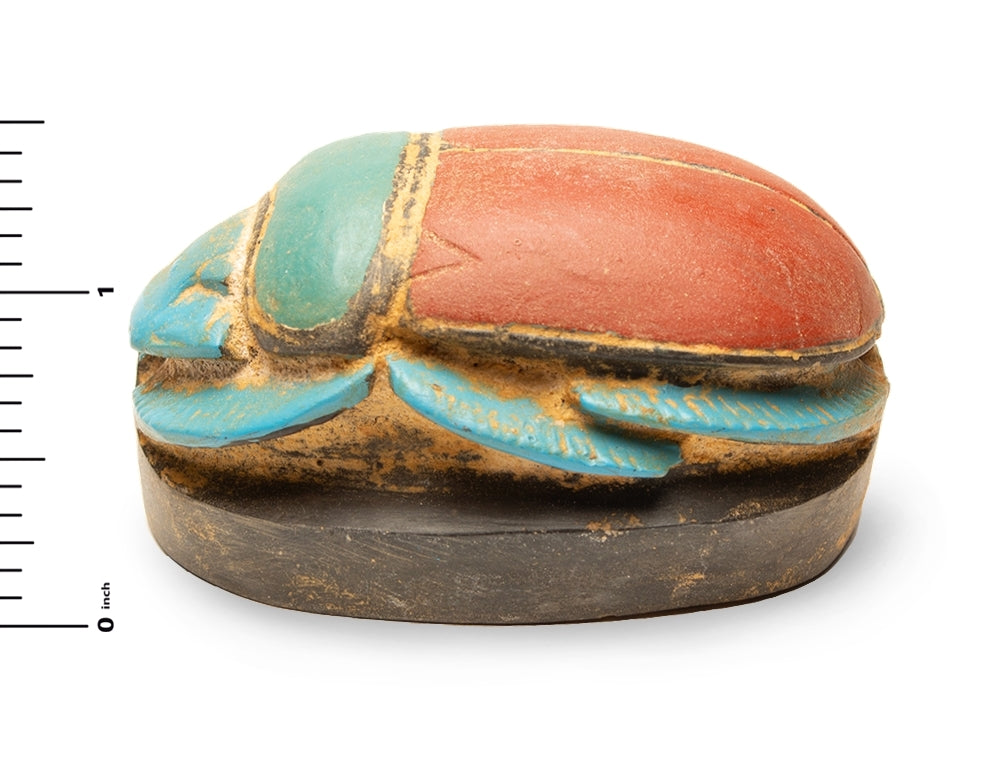 Decorative box shaped like a beetle with colored paint on a white background