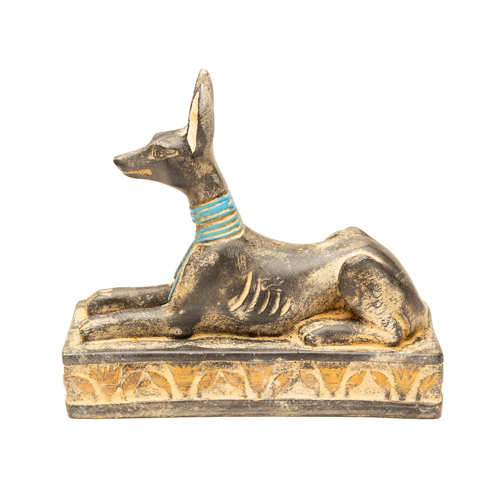 Statue of a seated Egyptian god on a white background