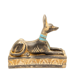 Statue of a dog with a blue collar on a white background