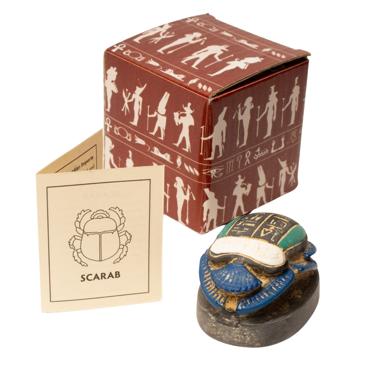 Decorative scarab beetle with packaging and card on a white background