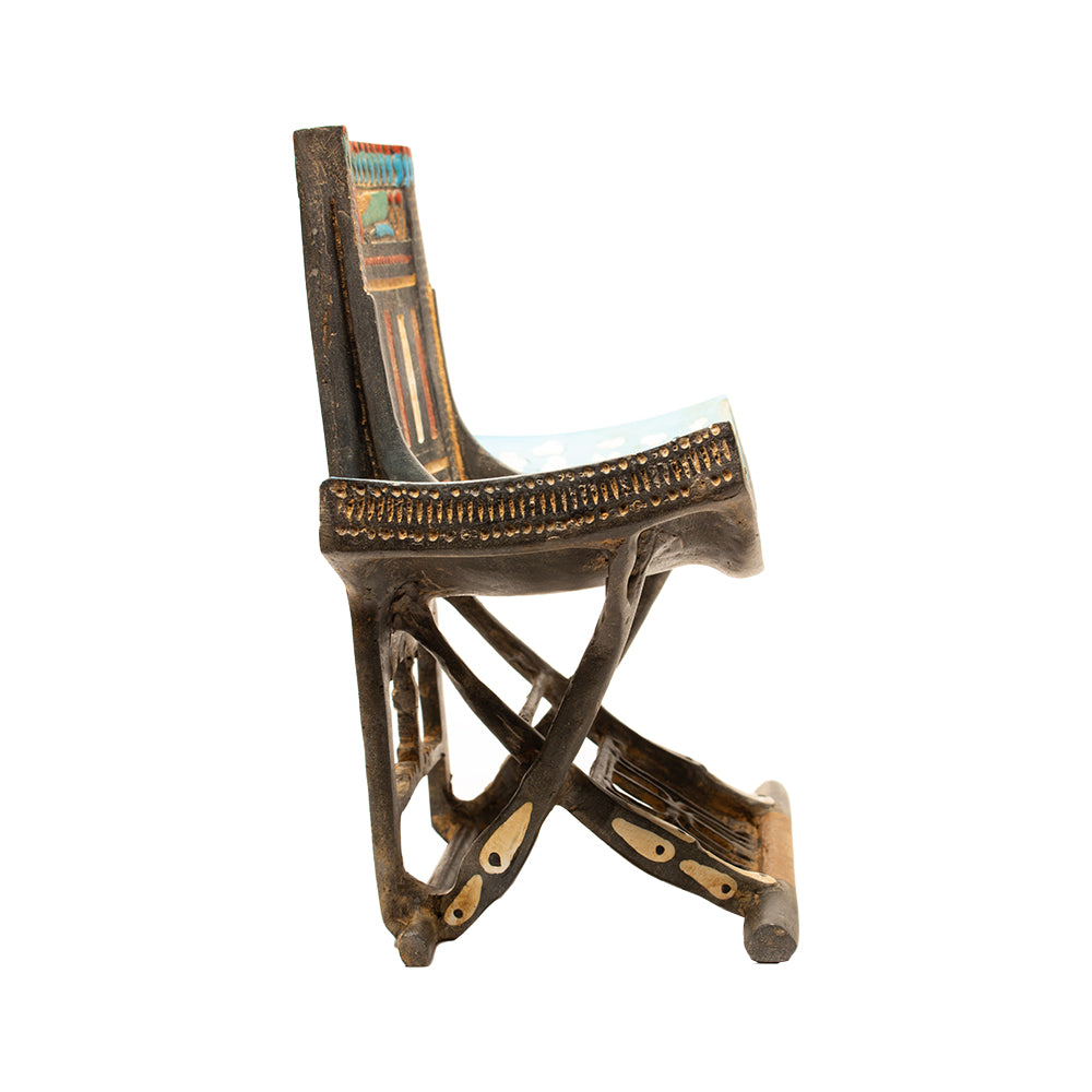 Decorative chair with intricate design on a white background