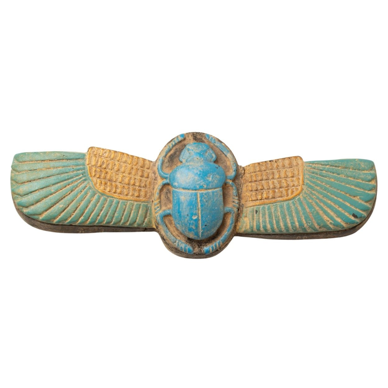 Decorative item with winged scarab design on a white background