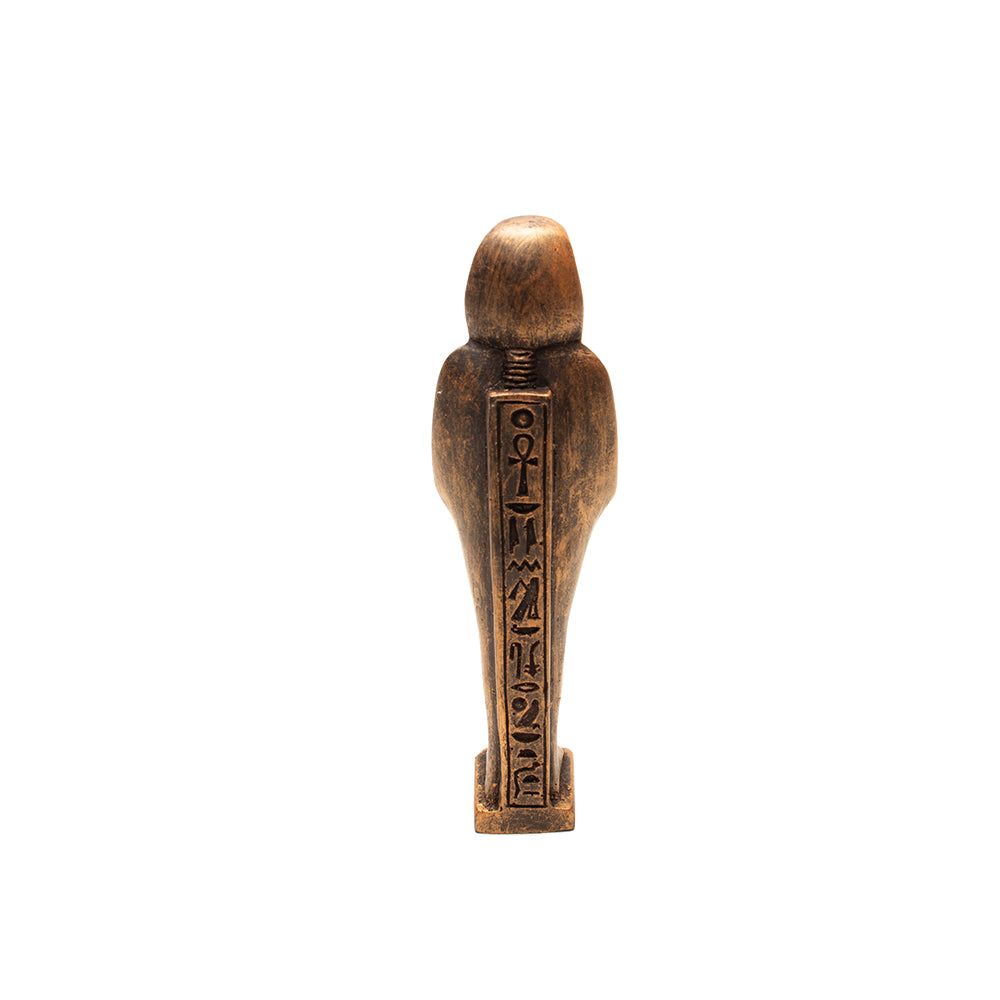 Wooden figurine with carvings on a white background