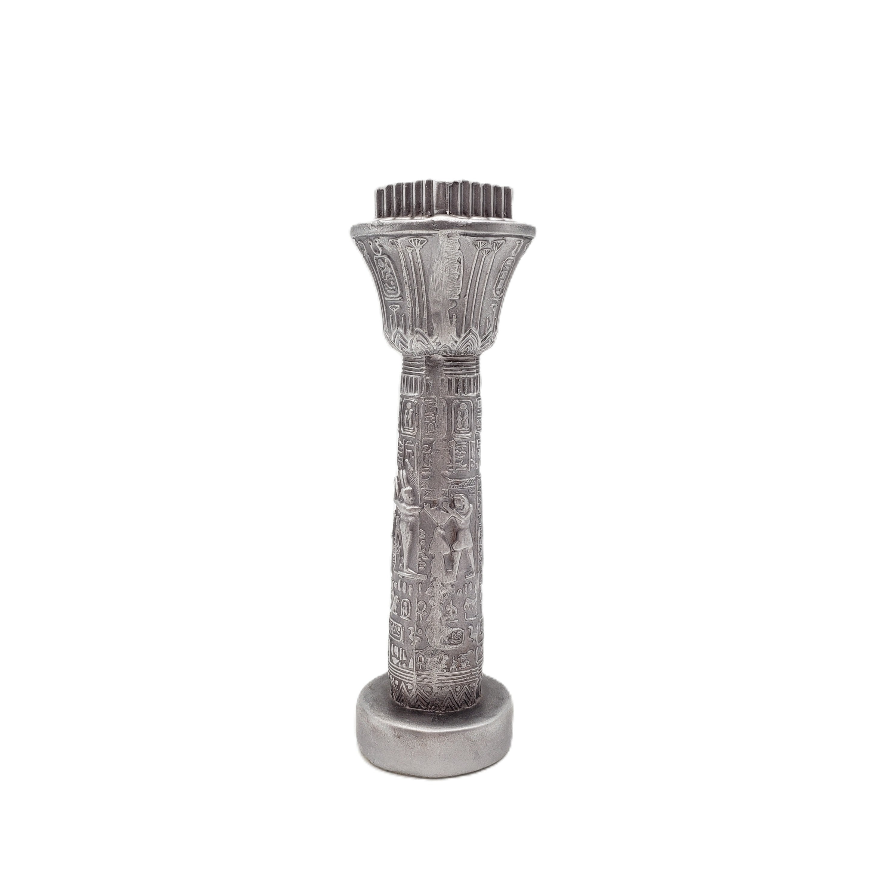 Decorative silver column with intricate designs on a white background