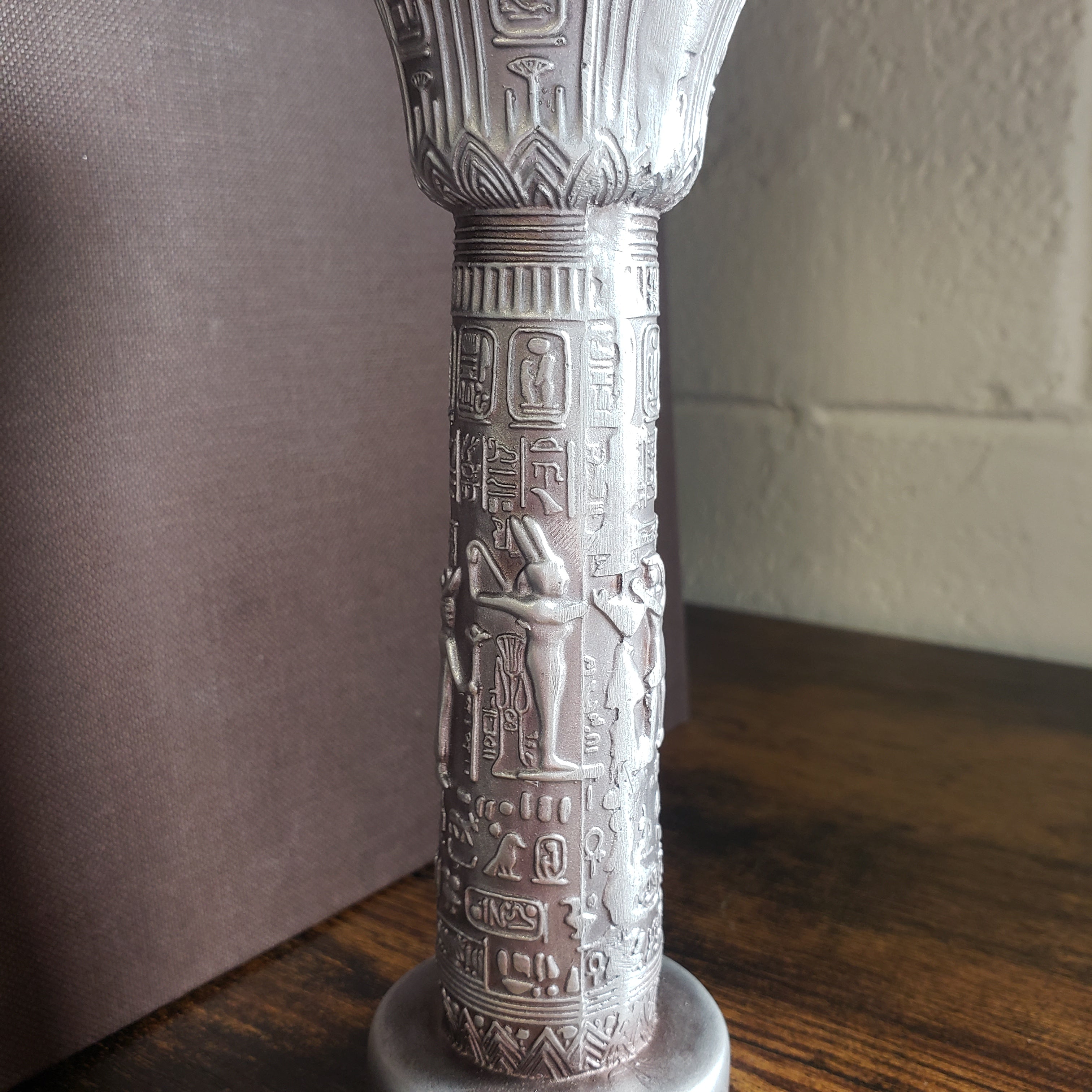 Decorative object with intricate carvings on a neutral background