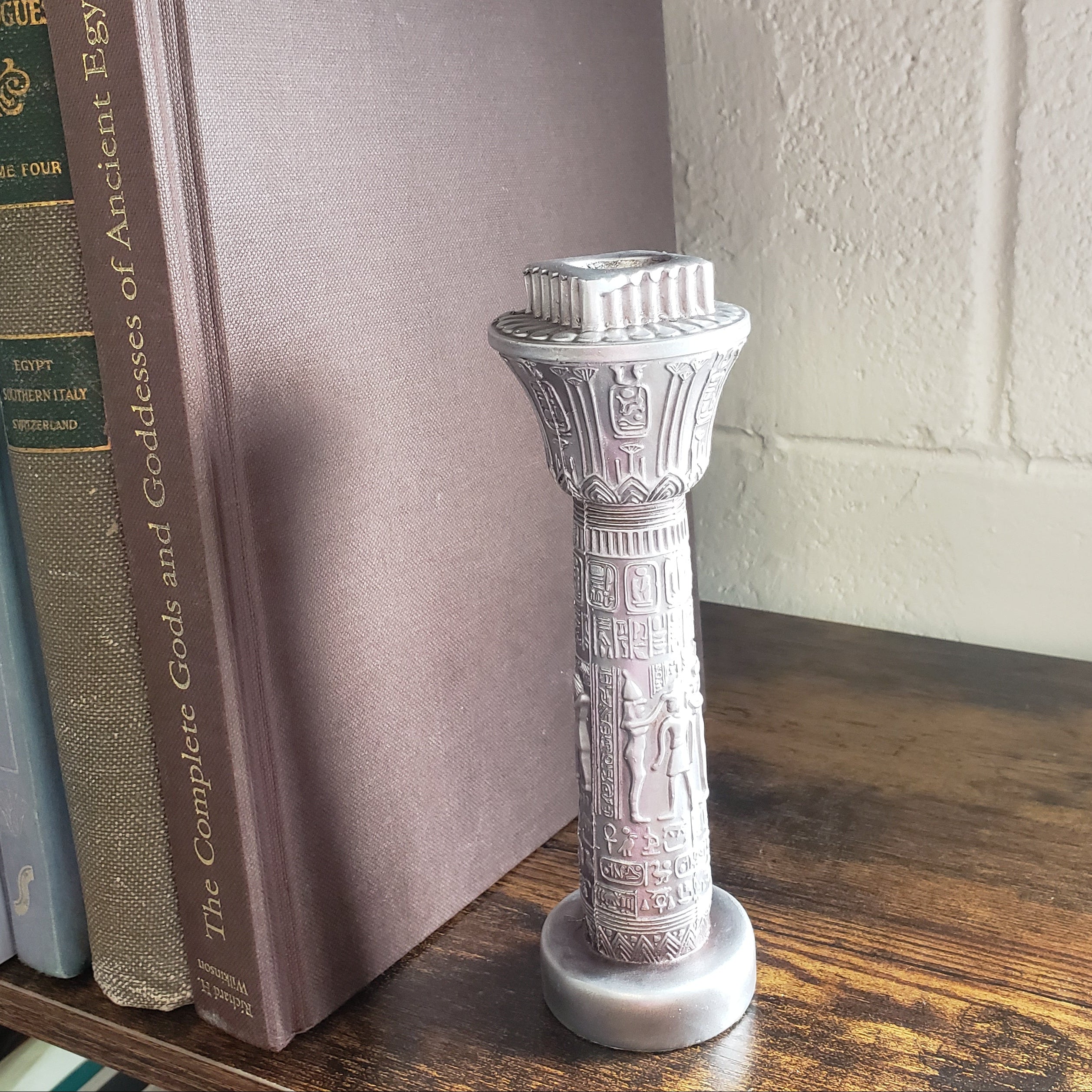 Decorative object on top of a book with a brick wall background