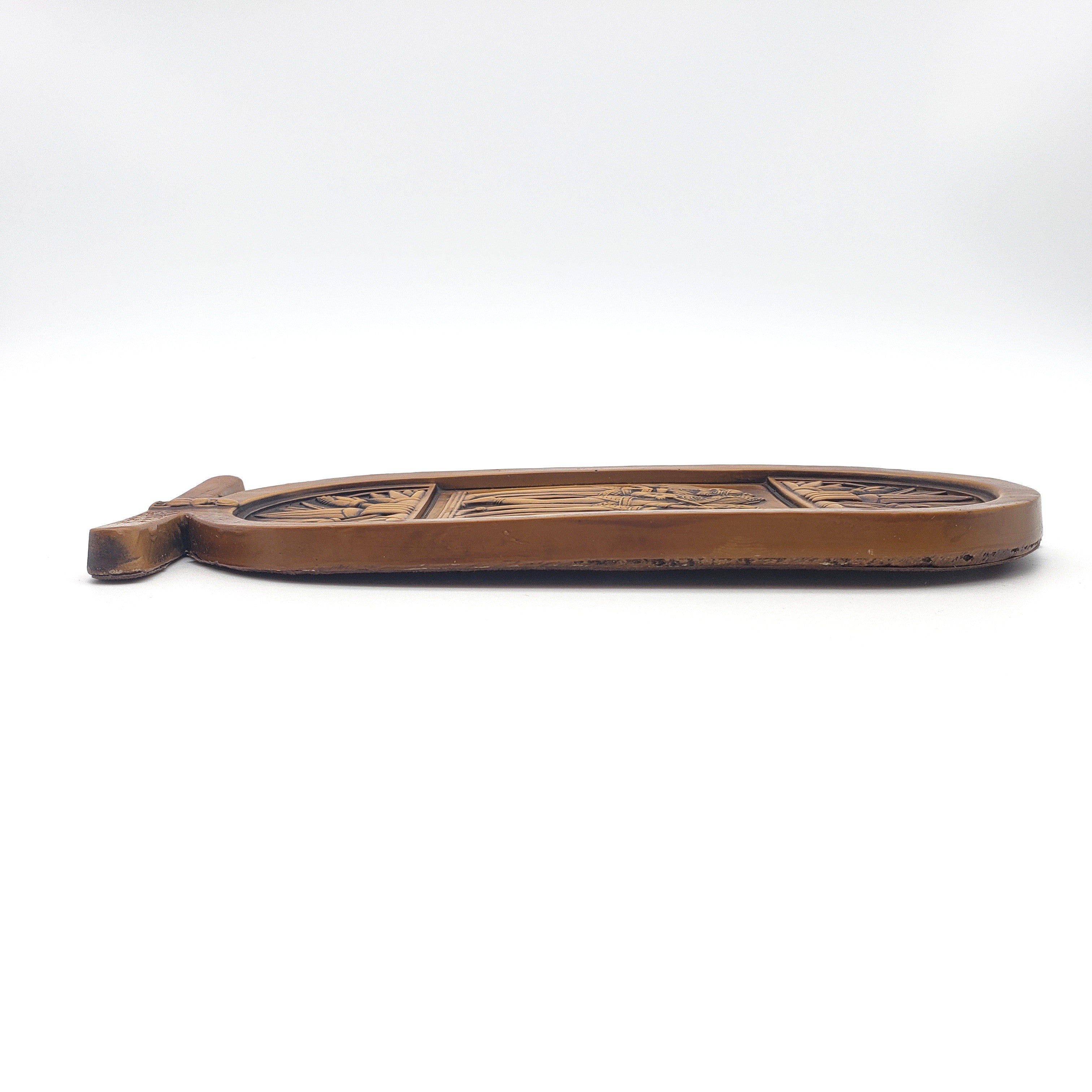 plaque with decorative carvings on a white background