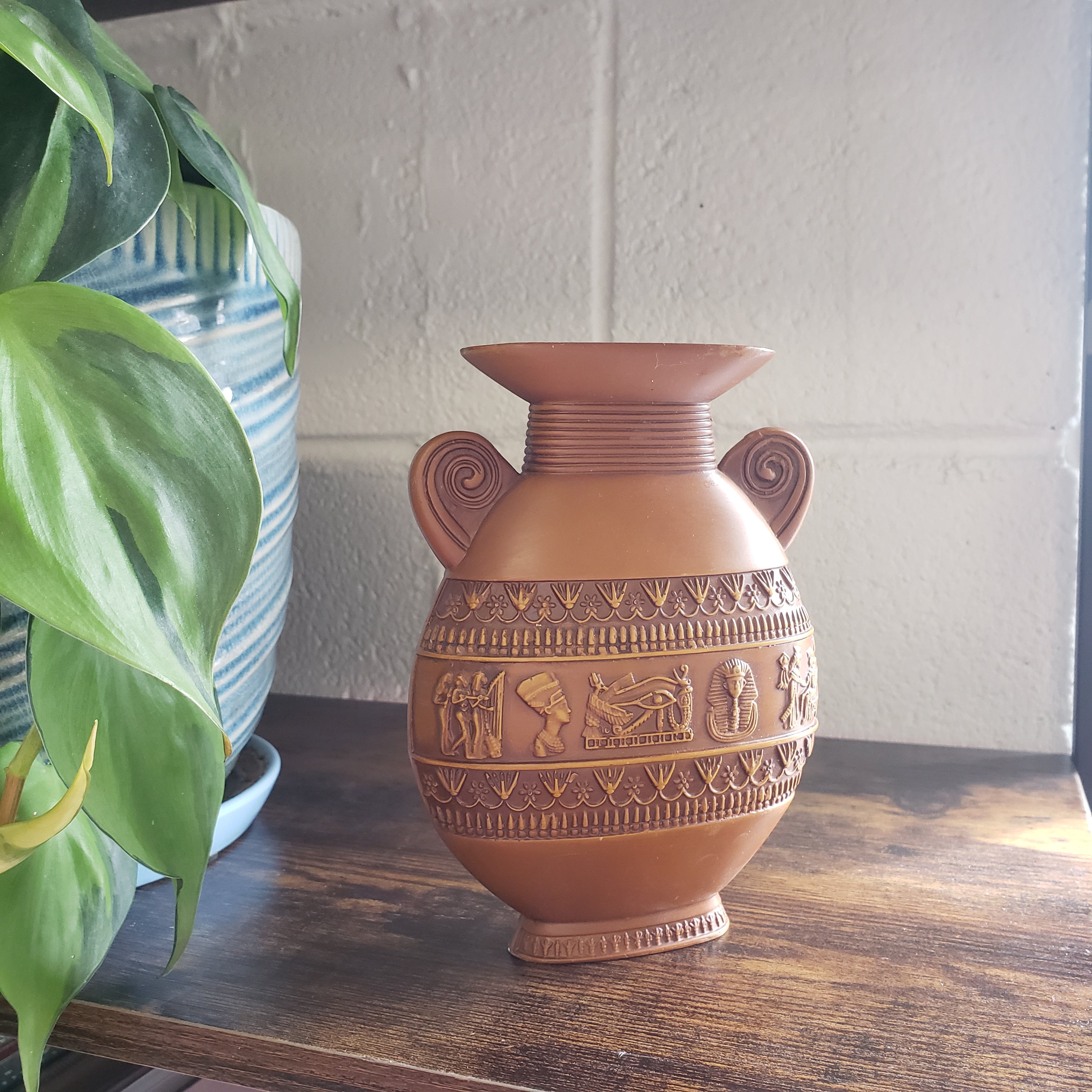 Decorative vase with intricate patterns on a wooden surface.