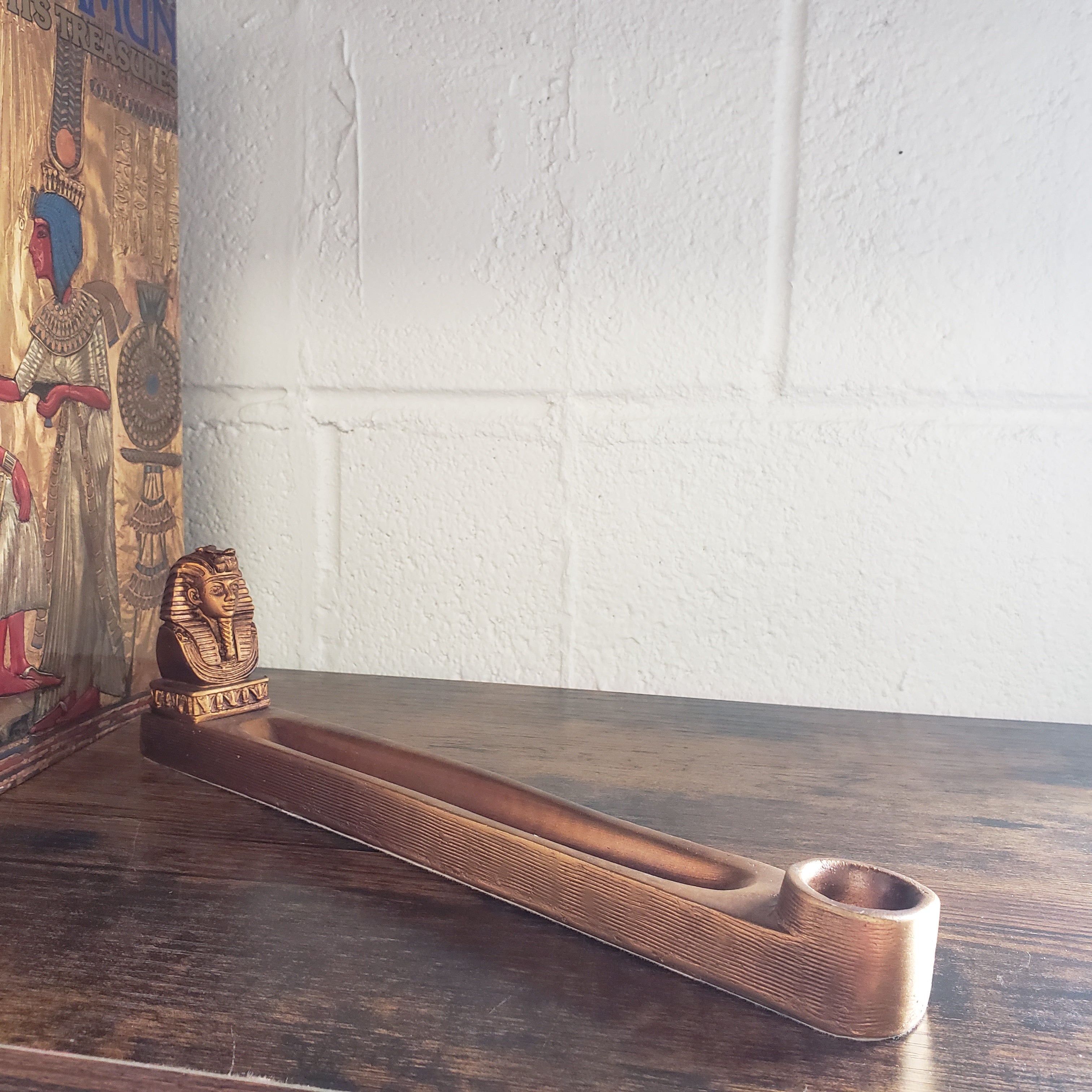 incense holder against a white wall