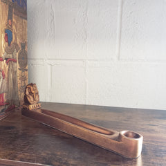 incense holder against a white wall