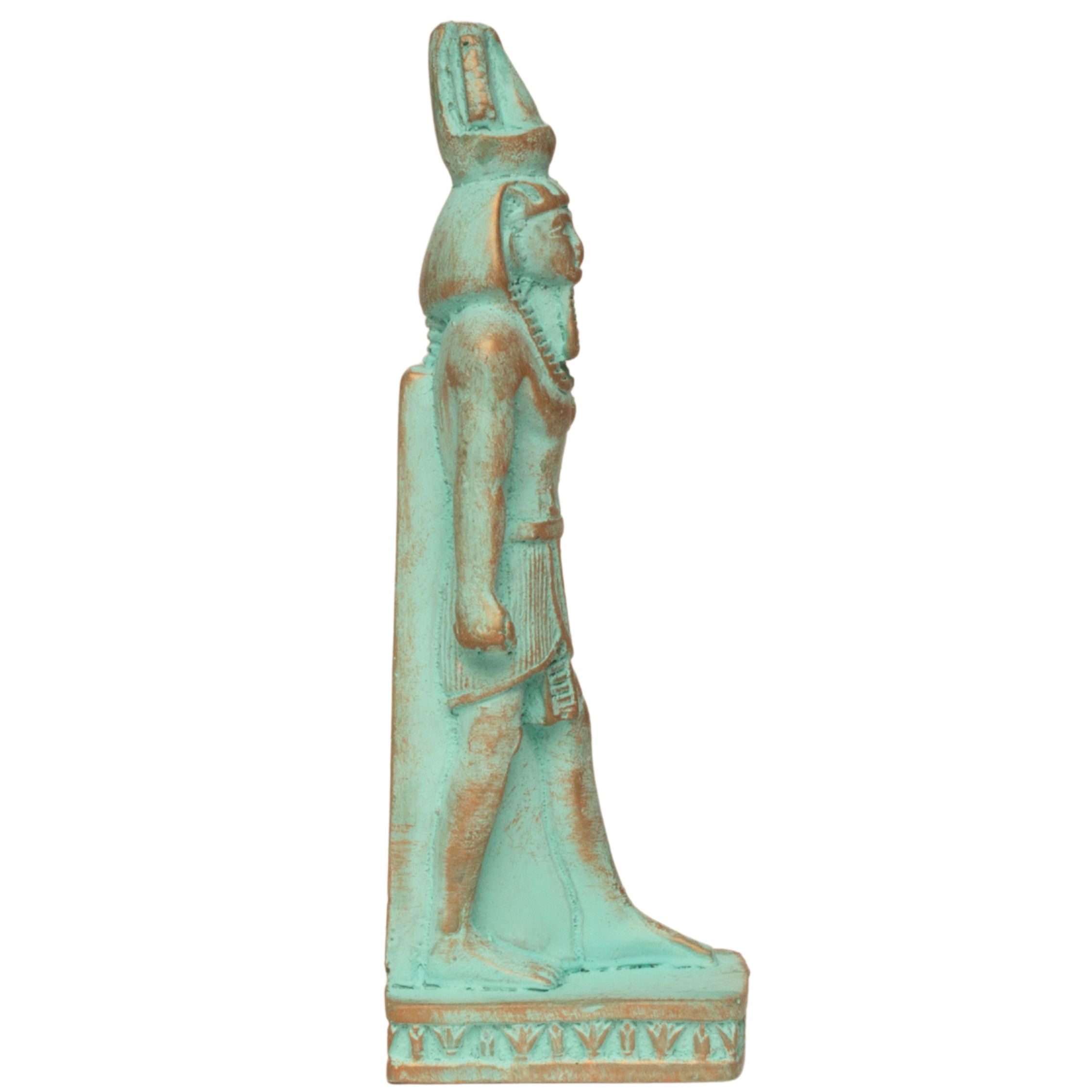 An Egyptian-style figurine of a standing figure with a tall headdress, shown in profile against a plain white background. The figure has a distressed turquoise and gold finish.