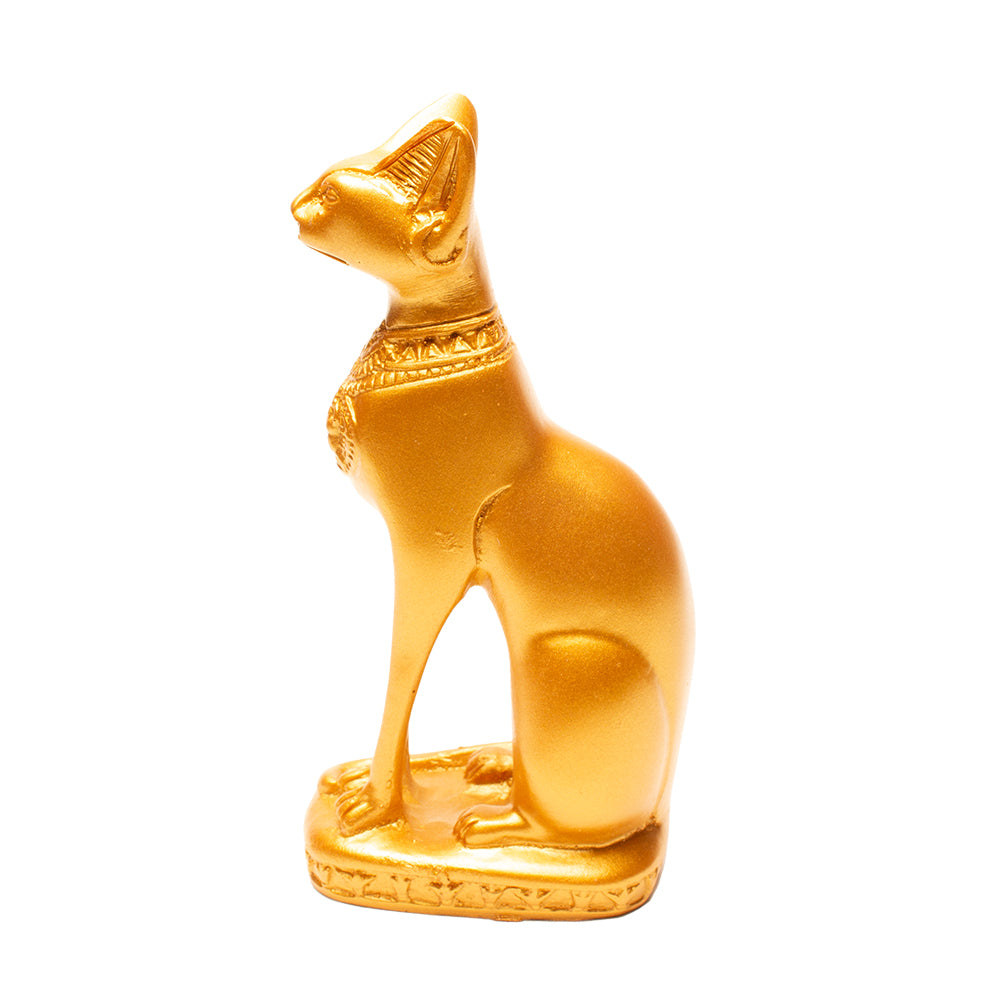 Gold cat figurine with intricate designs on a white background