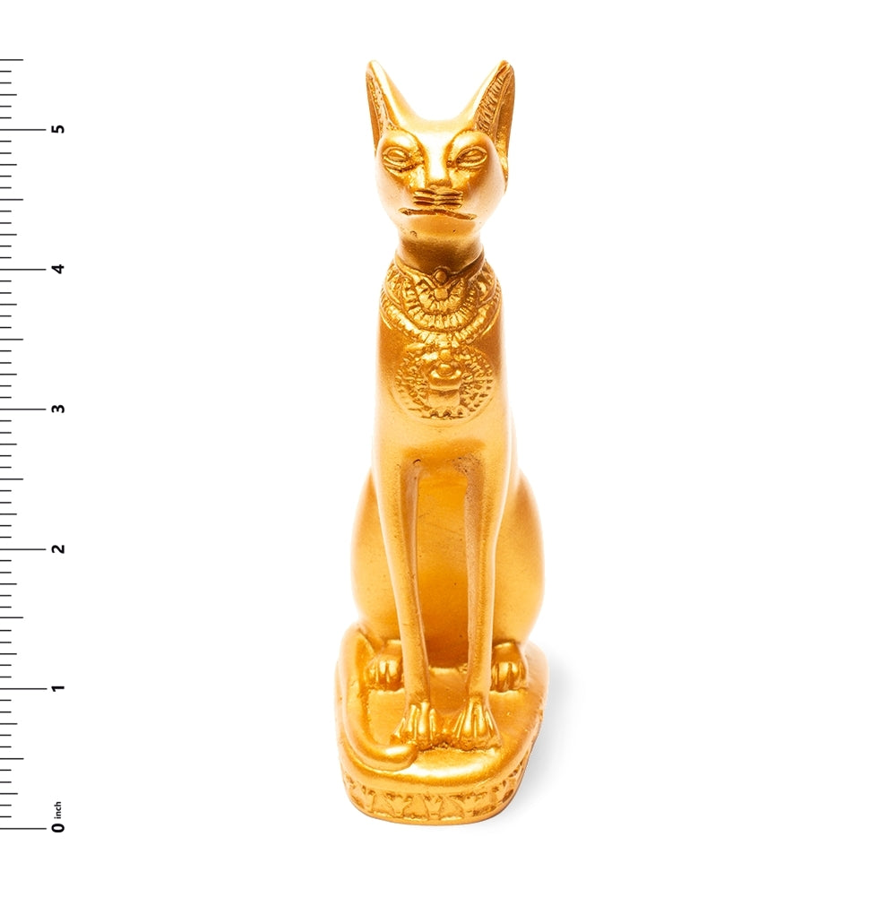 Gold cat figurine with decorative patterns on a white background