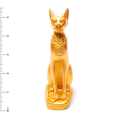 Gold cat figurine with decorative patterns on a white background