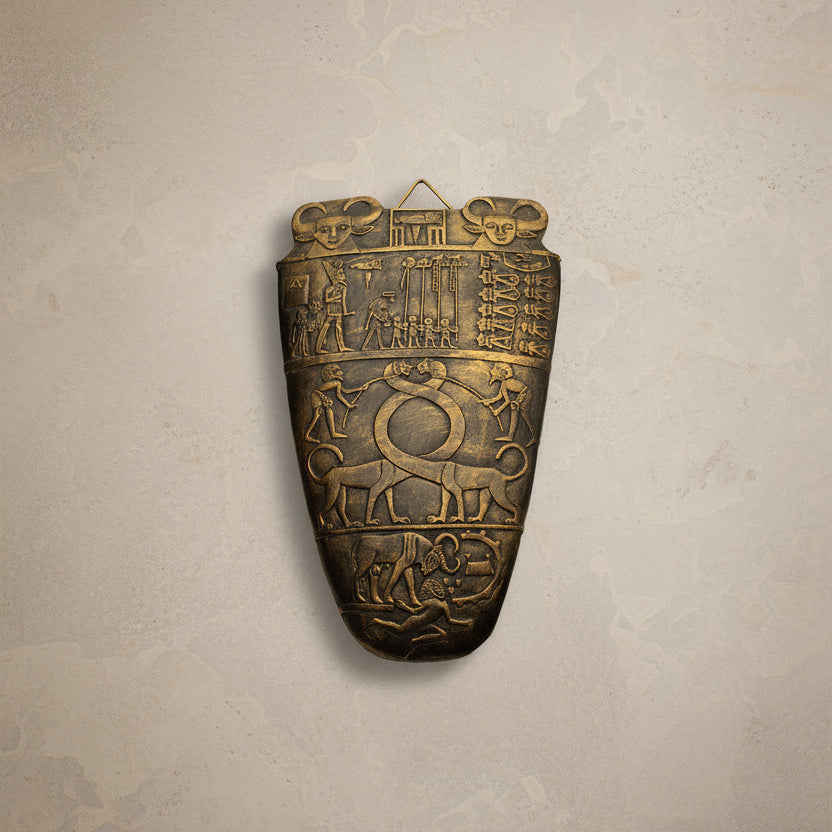 Bronze artifact with intricate carvings on a white background