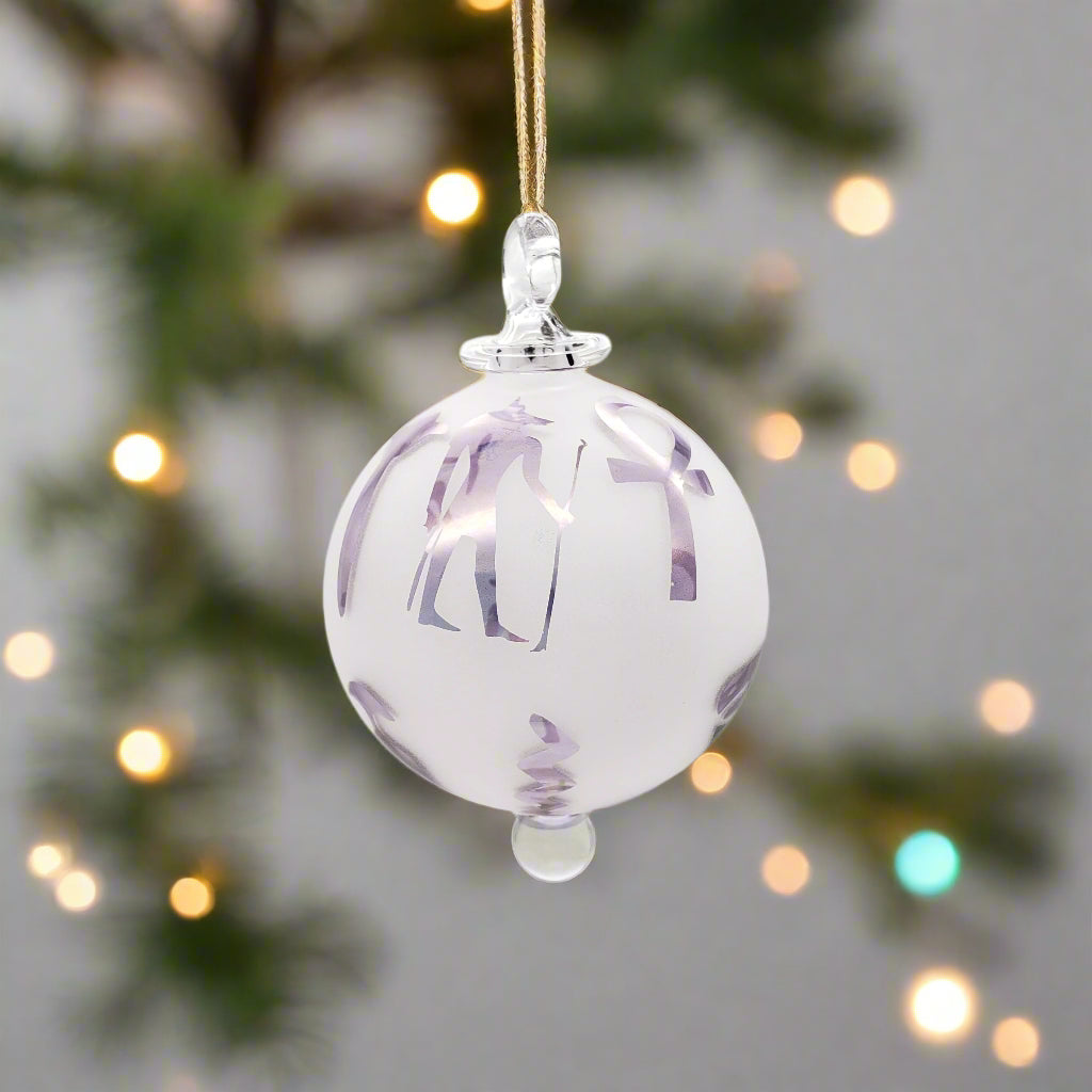 Decorative glass ornament with purple patterns on a white background