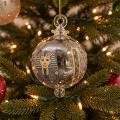 Decorative Christmas ornament with Egyptian-themed design on a tree.