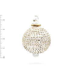 Decorative ornament with gold beads on a white background