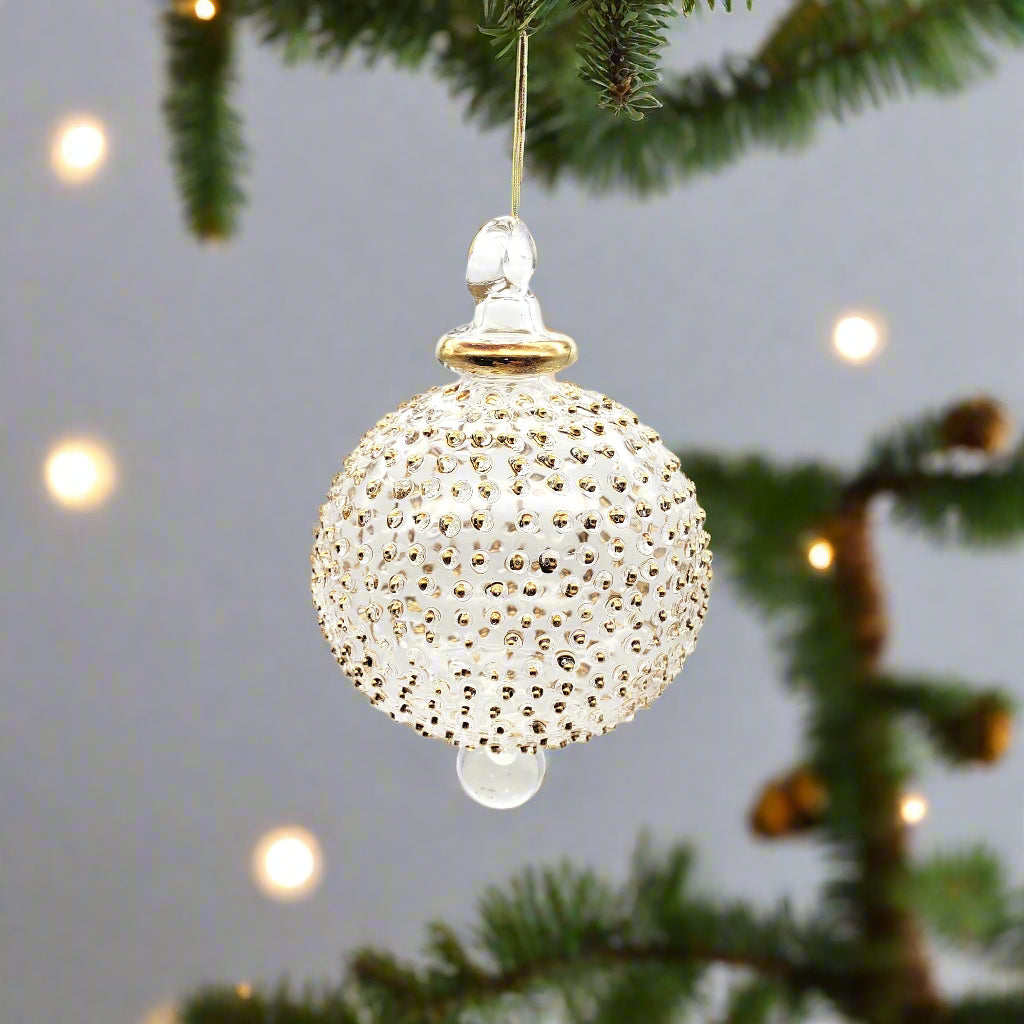 Decorative ornament with gold embellishments on a white background