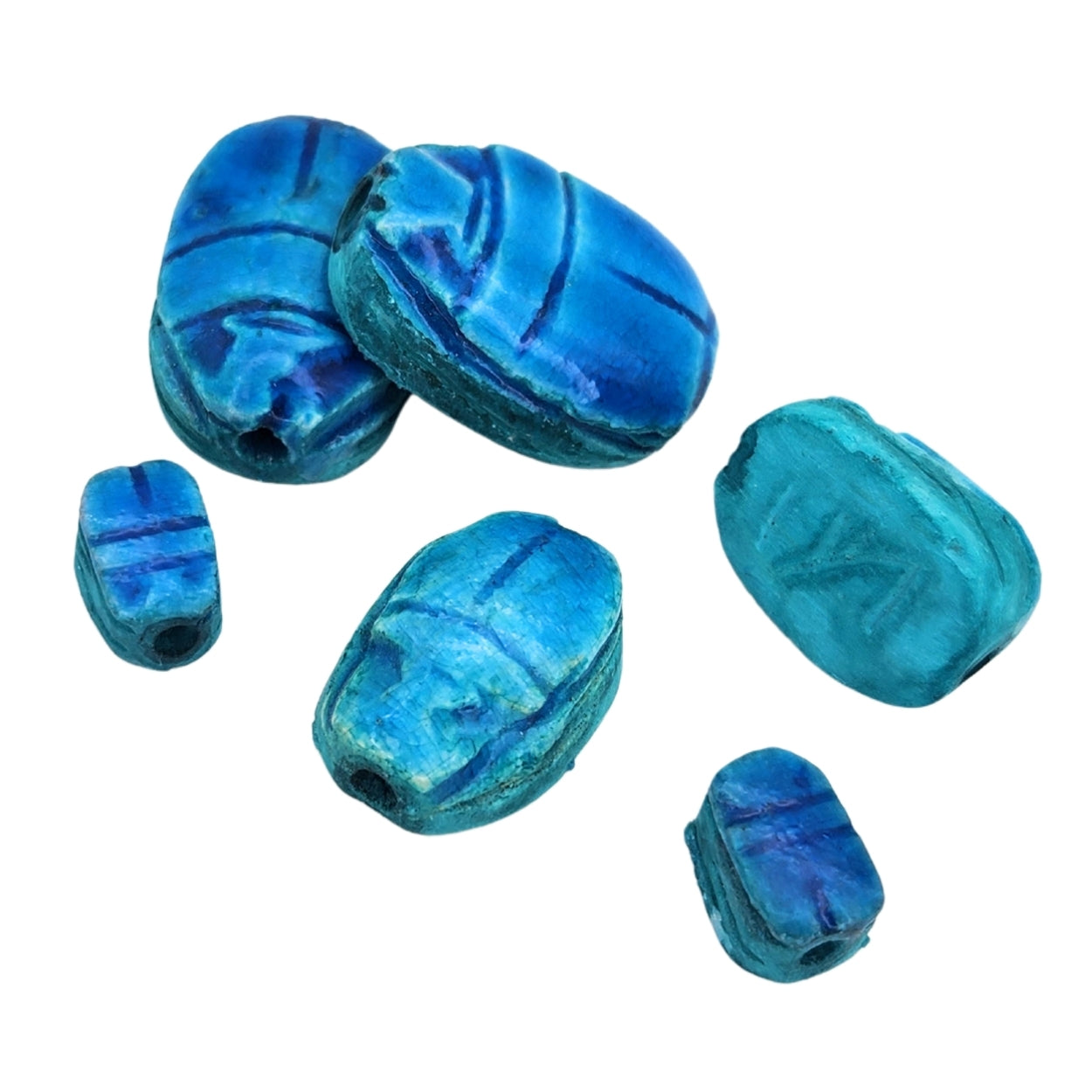 Blue stone scarab beetles on a white background