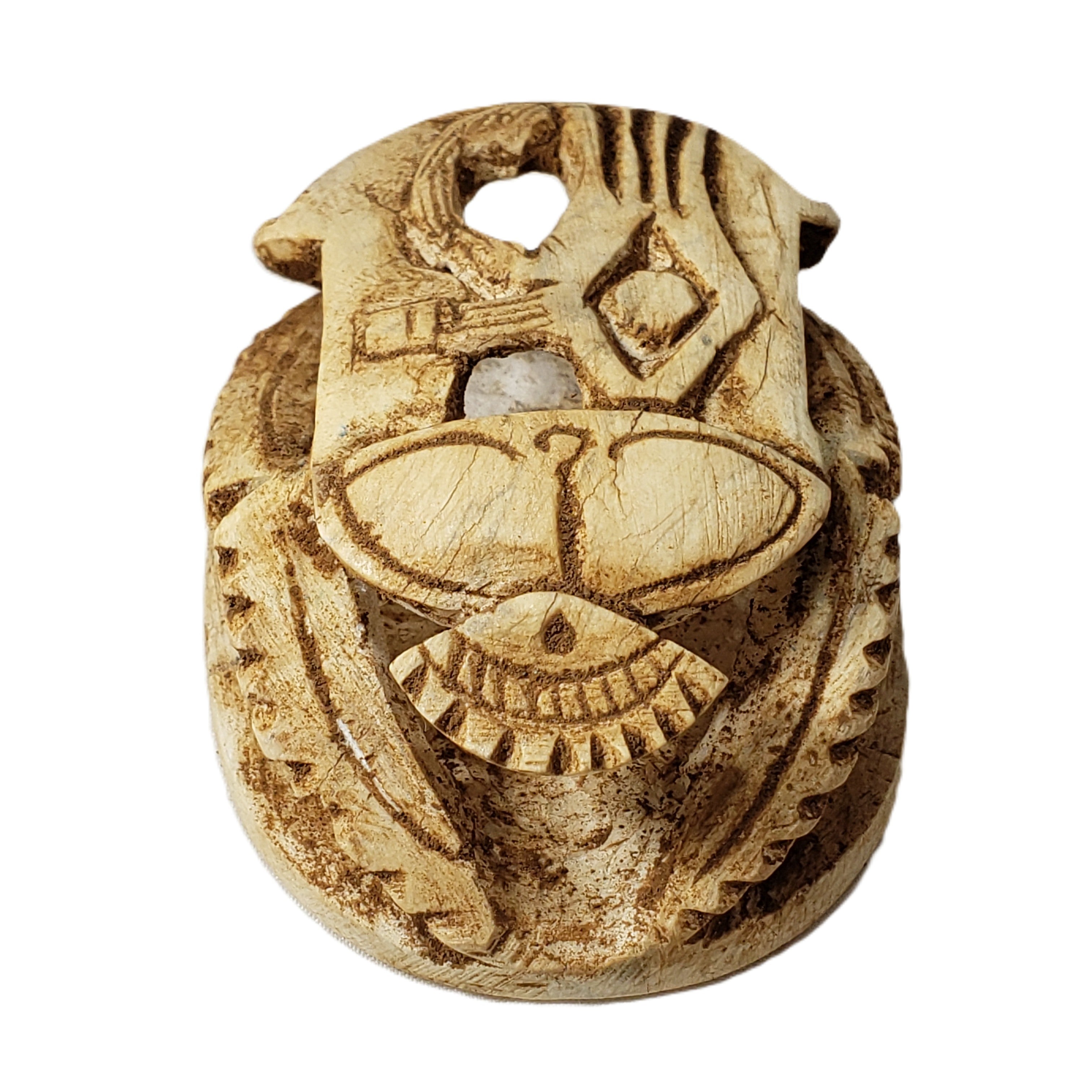 Decorative stone pendant with intricate carvings on a white background