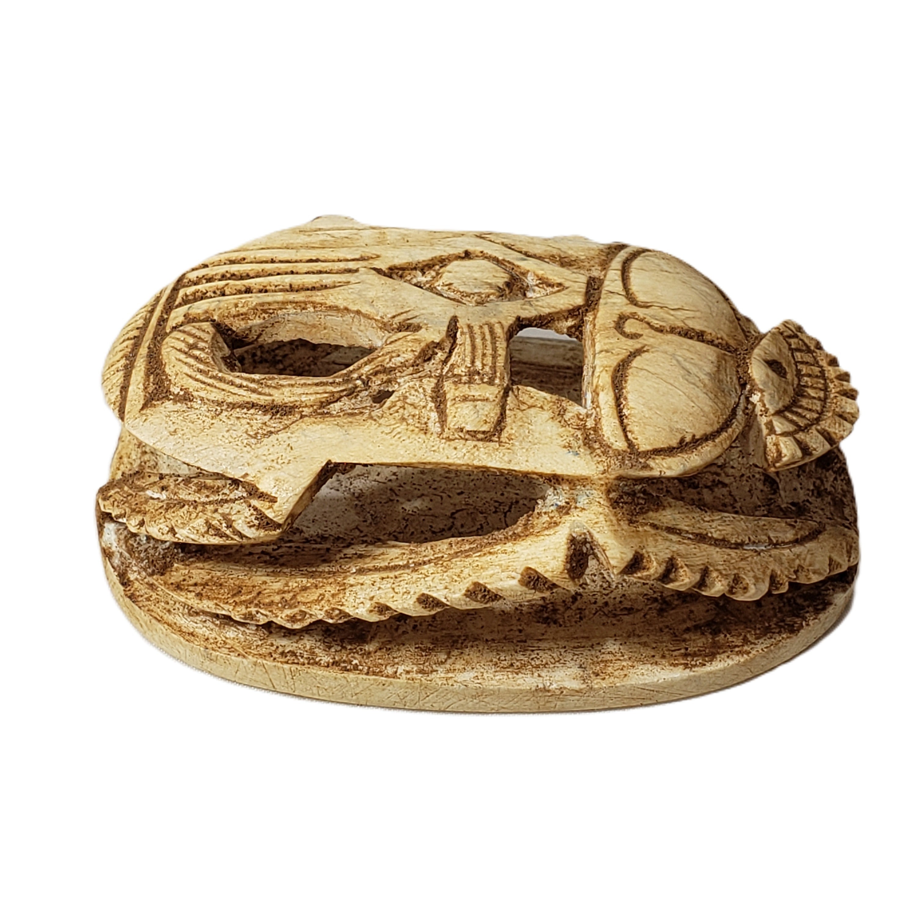 Carved wooden object with intricate patterns on a white background