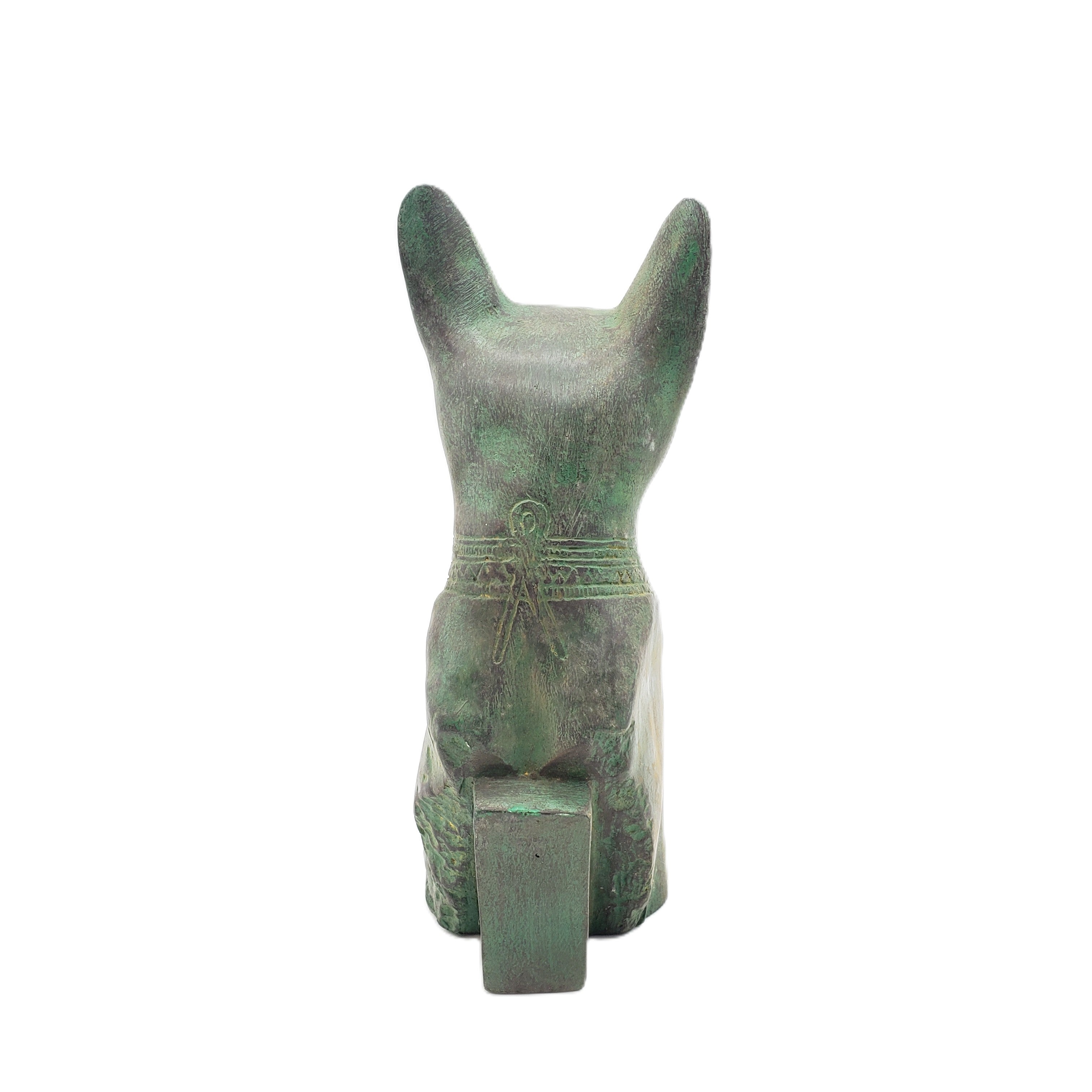 Green stone sculpture of a cat with a white background