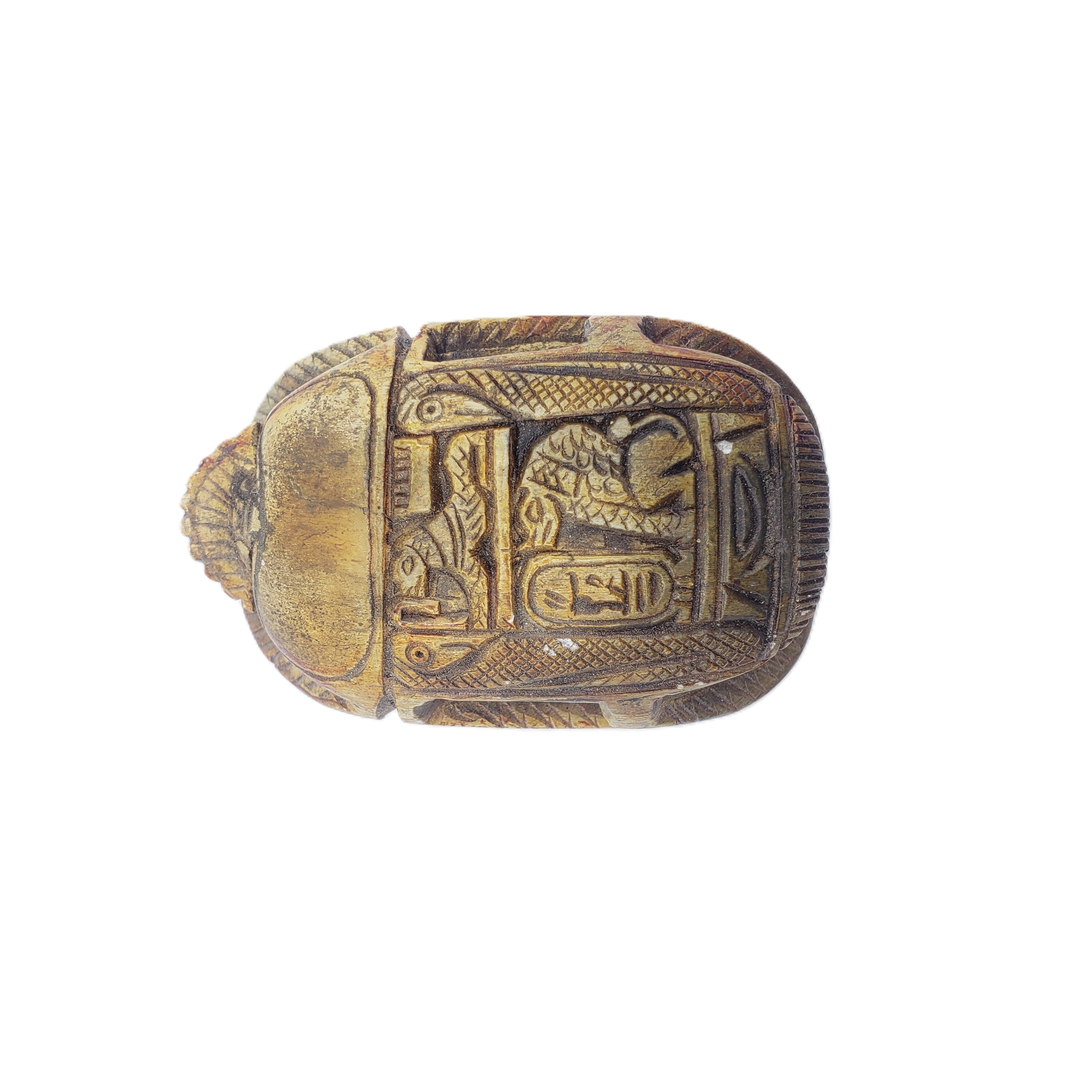 Decorative scarab statue object with intricate carvings on a white background