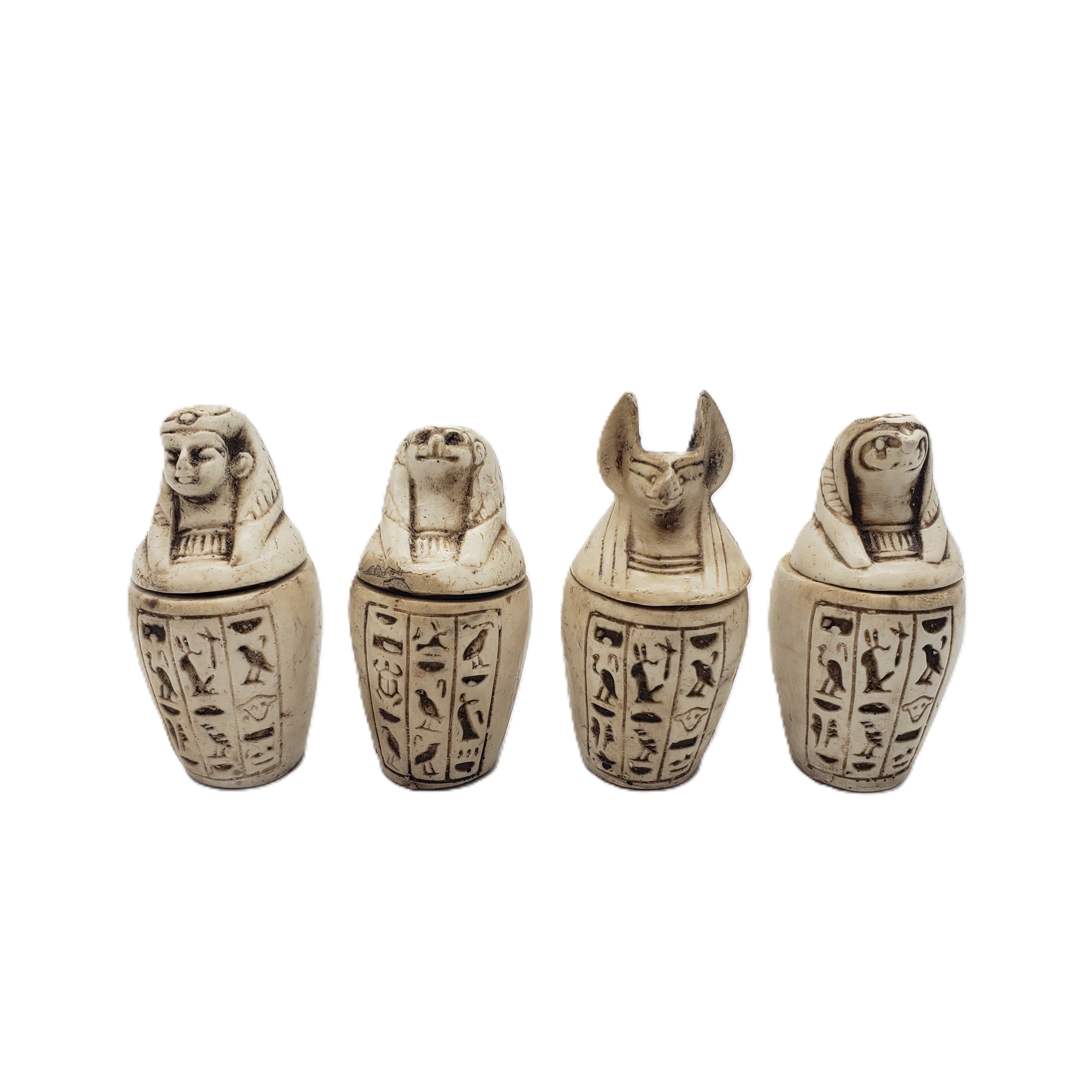 Four Egyptian-style canopic jars with hieroglyphics on a white background