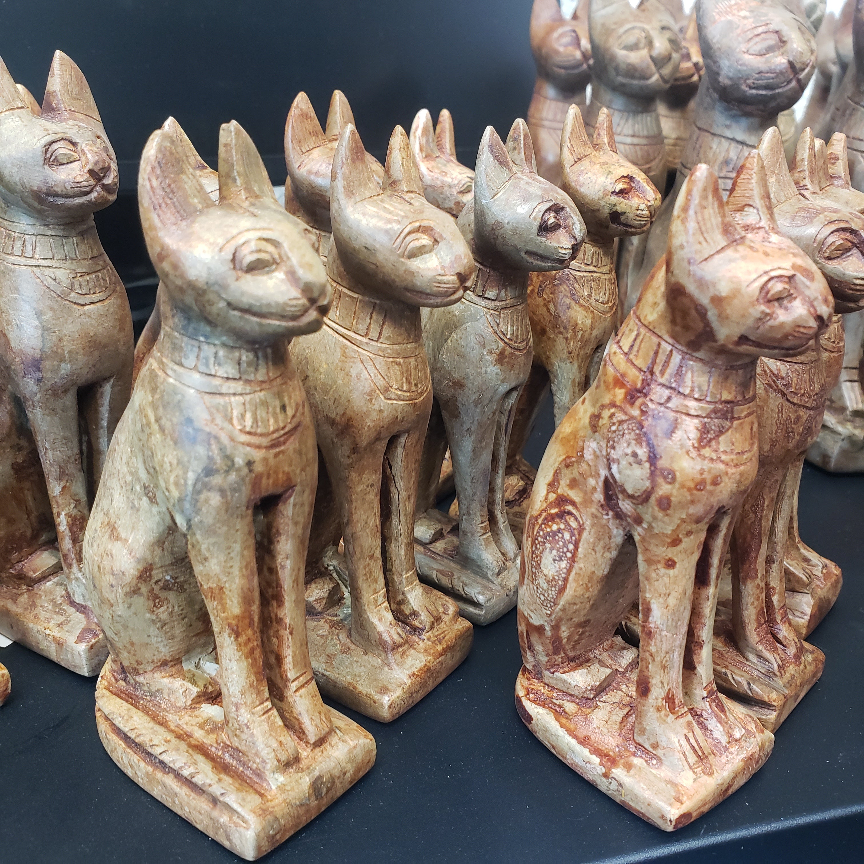 Collection of stone carvings of animals on a dark surface