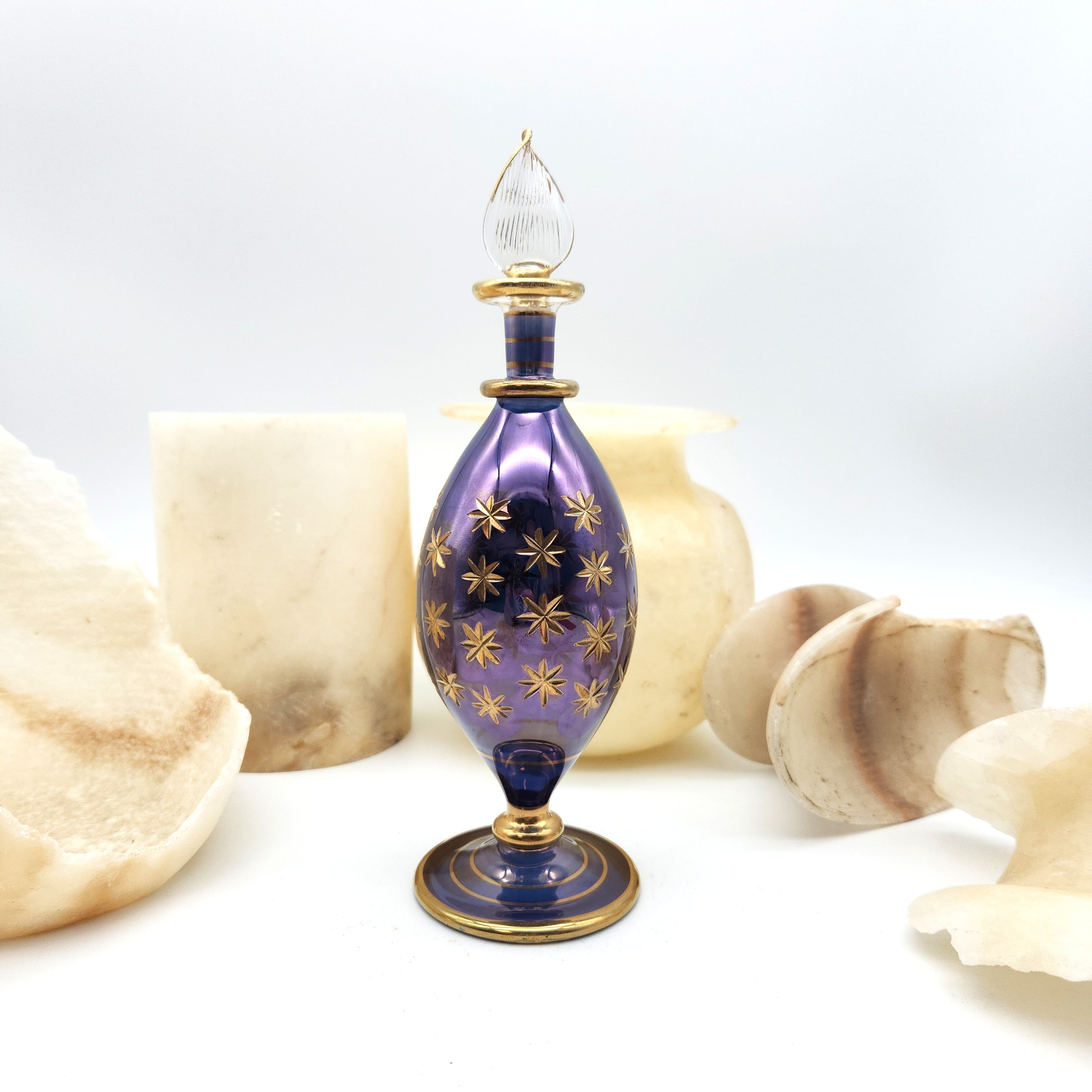 Decorative purple and gold bottle on a white background