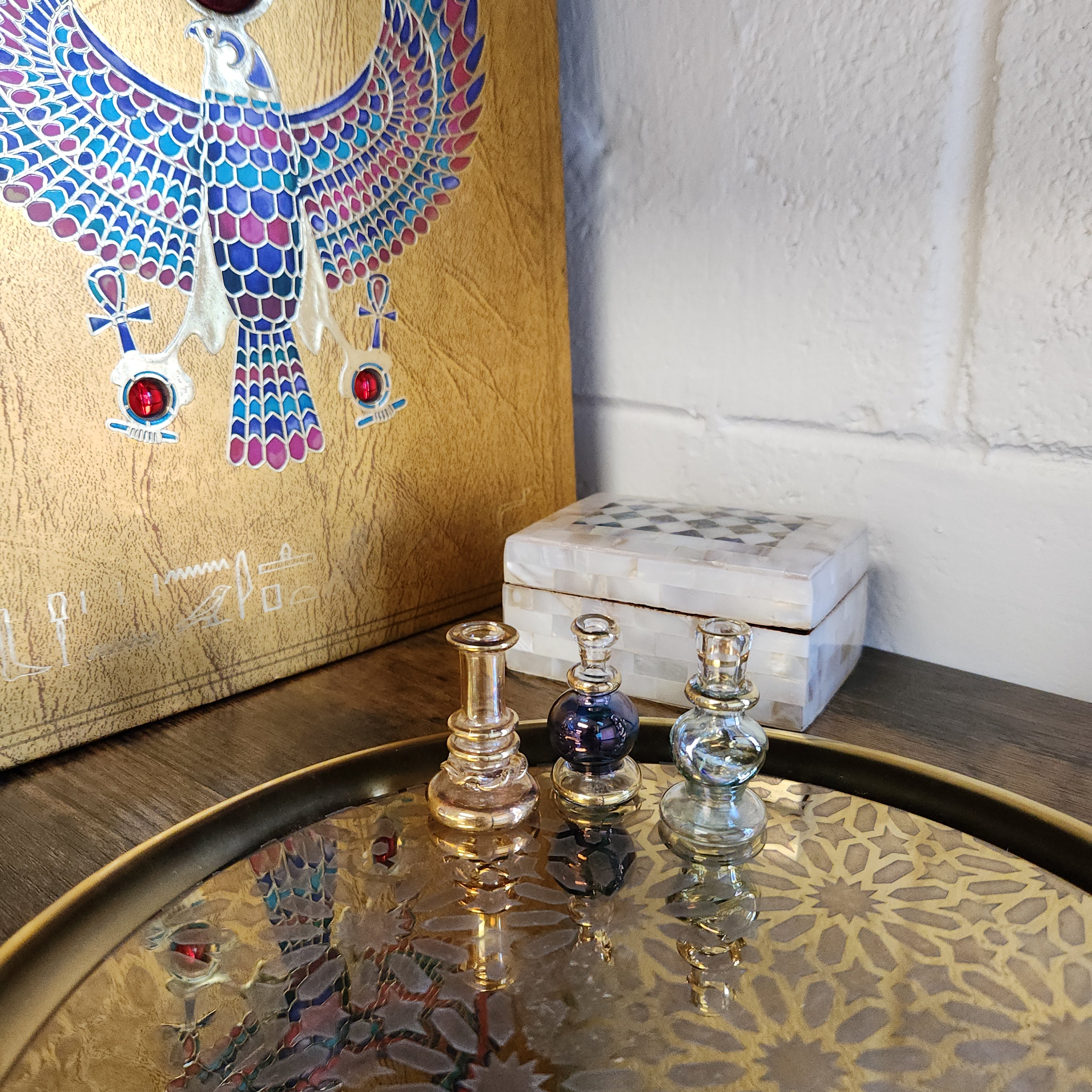 Close-up of a decorative object with intricate designs and patterns on a wooden surface.