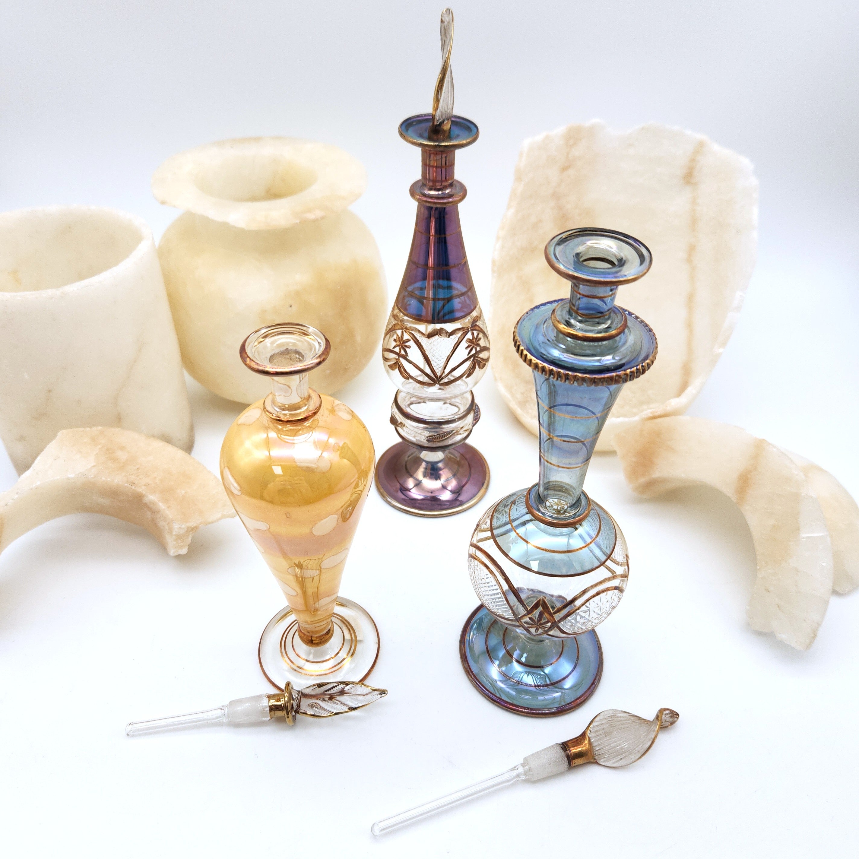 Decorative glass vases and candle holders on a white background