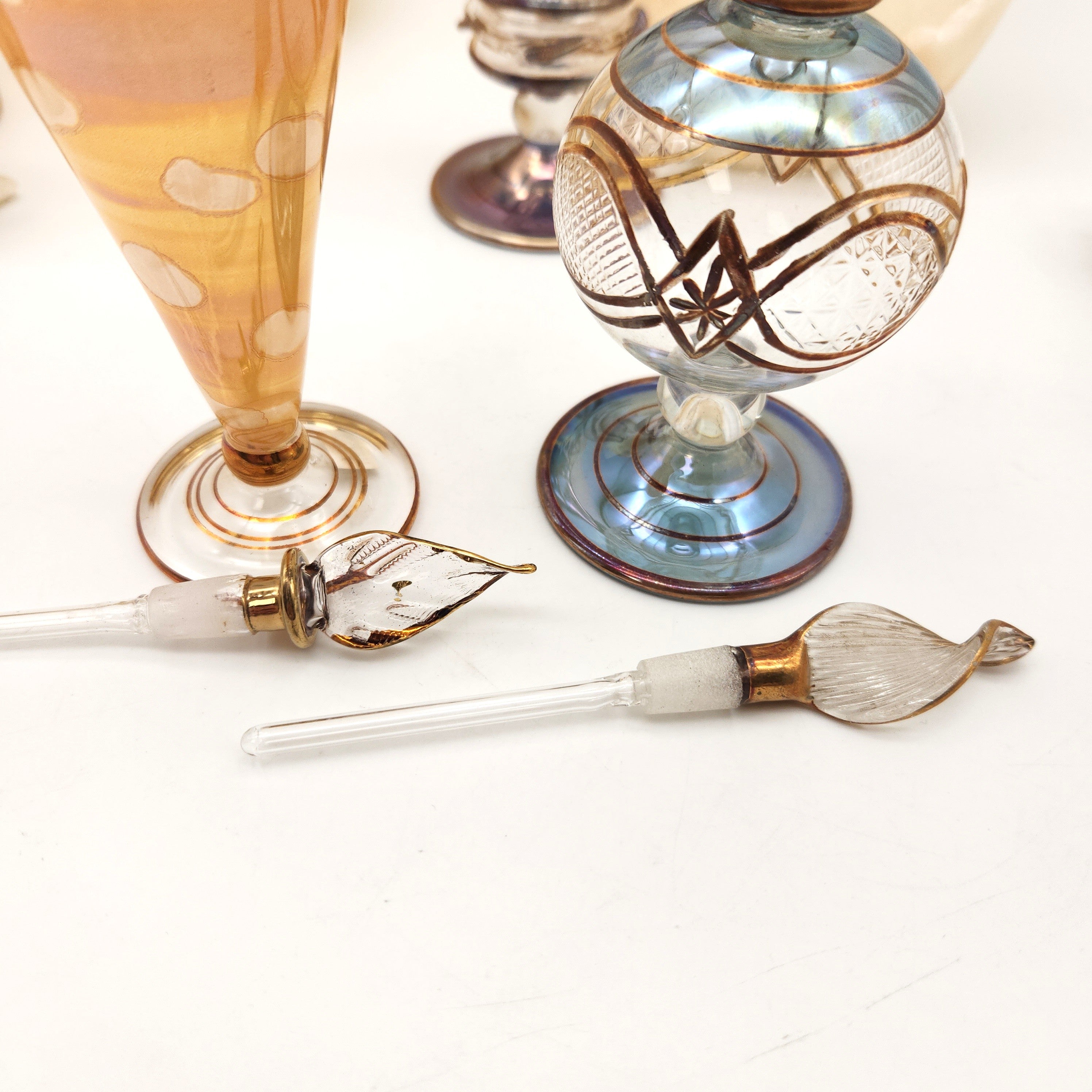 Decorative glass items with intricate designs on a white surface