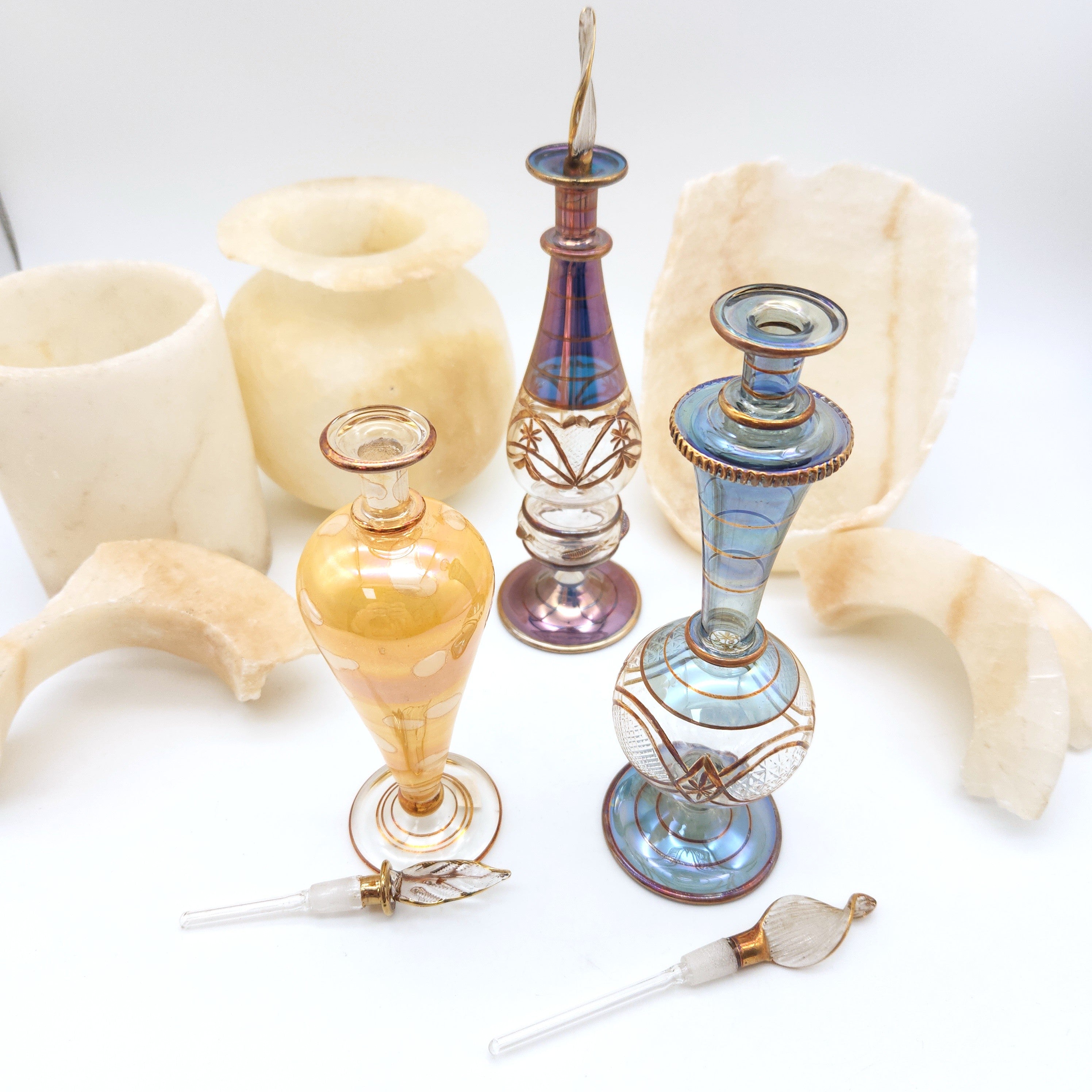 Collection of decorative glass perfume bottles on a white background