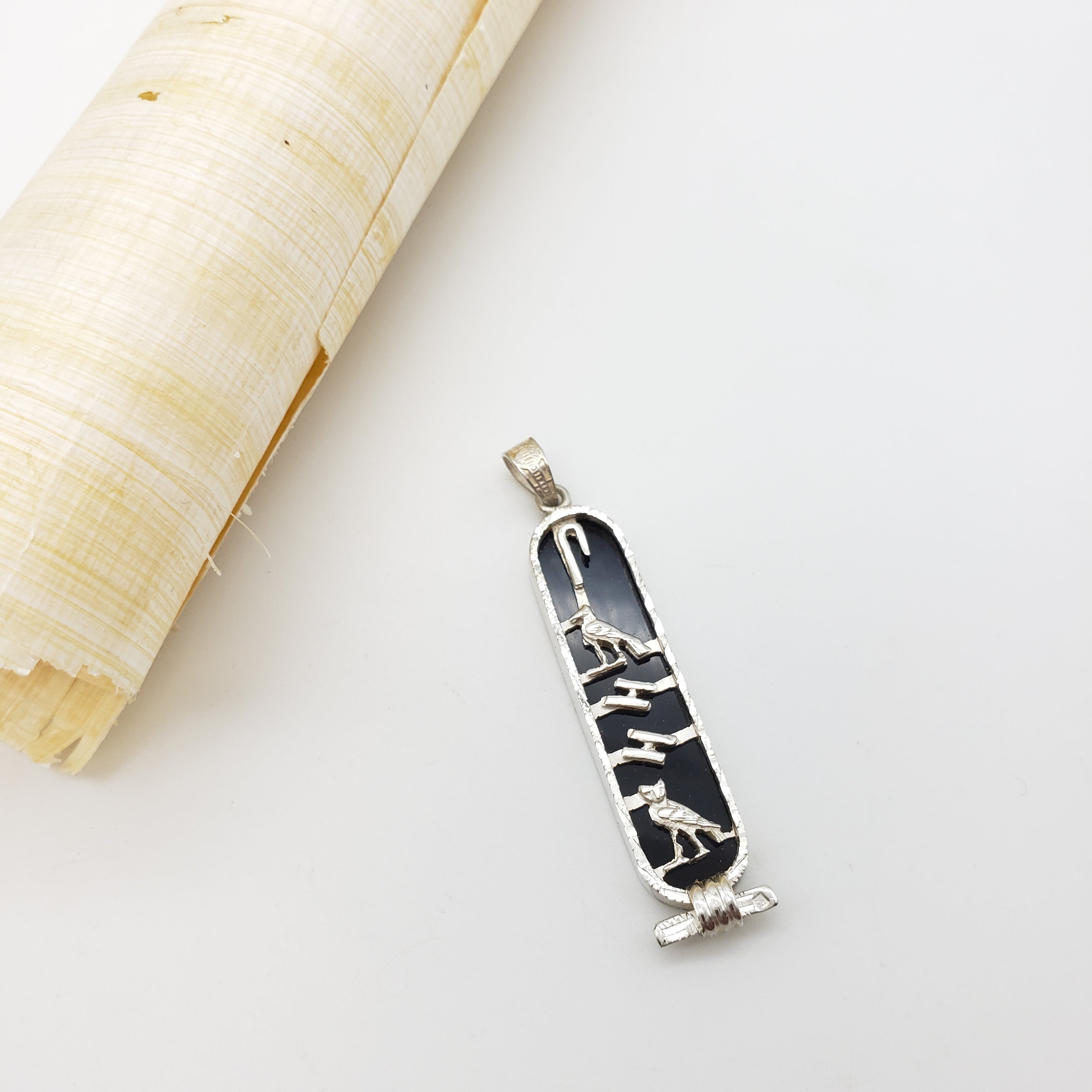 Silver cartouche with black pattern on a white background