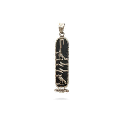 Decorative pendant with black and gold design on a white background