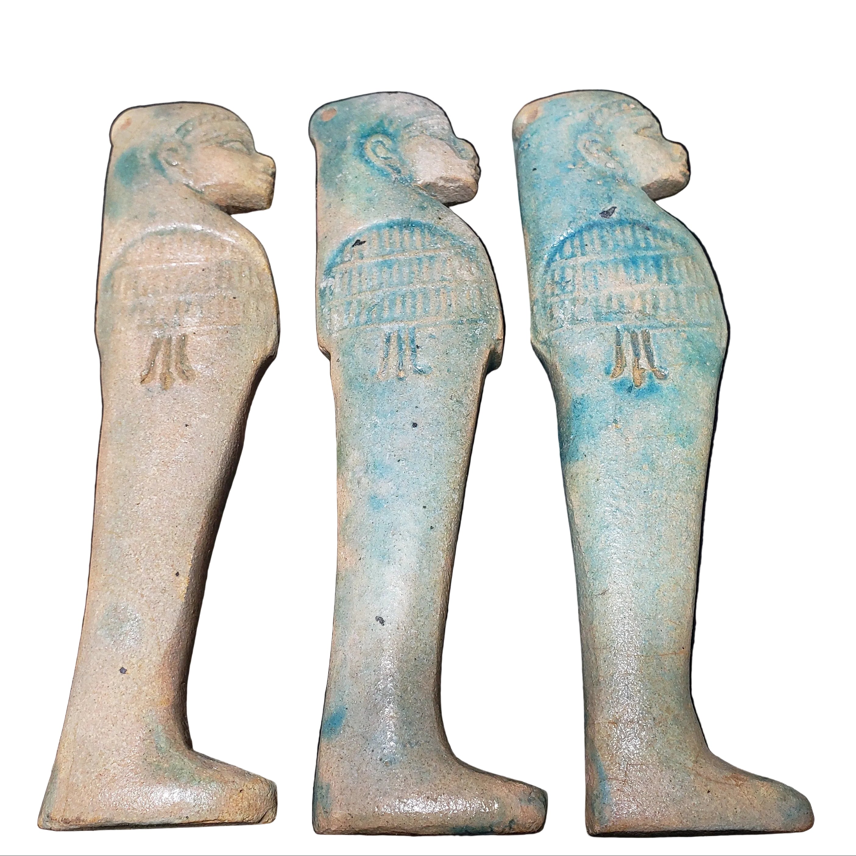 A set of four blue ceramic canopic figures representing the four sons of Horus, each with a different facial expression and detailing.